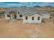 New construction home featuring a brick entryway, gray roof and white exterior at 9486 W Sandstone Mountain Dr, Casa Grande, AZ 85194