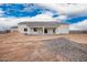 The rear exterior of a white home and covered patio with construction materials nearby at 9486 W Sandstone Mountain Dr, Casa Grande, AZ 85194