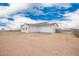 A modern home features a three-car garage with white doors and an attached exterior at 9486 W Sandstone Mountain Dr, Casa Grande, AZ 85194