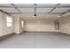 A two car garage with an installed water heater on the wall near a pair of windows at 9486 W Sandstone Mountain Dr, Casa Grande, AZ 85194
