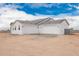 A modern home features a three-car garage with white doors and an attached exterior at 9486 W Sandstone Mountain Dr, Casa Grande, AZ 85194