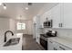 Modern kitchen with white cabinets, stainless steel appliances, and quartz countertops at 9486 W Sandstone Mountain Dr, Casa Grande, AZ 85194