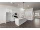 Beautiful kitchen with an island, quartz countertops, white cabinets, and stainless appliances at 9486 W Sandstone Mountain Dr, Casa Grande, AZ 85194