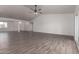 Bright and airy living room with vaulted ceiling, ceiling fan, tile floors and sliding glass door at 9486 W Sandstone Mountain Dr, Casa Grande, AZ 85194