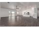 Open-concept living room and kitchen area with wood-look floors and plenty of light at 9486 W Sandstone Mountain Dr, Casa Grande, AZ 85194
