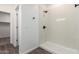 Bright white shower with a rain shower head and black fixtures at 9486 W Sandstone Mountain Dr, Casa Grande, AZ 85194