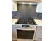 Updated kitchen featuring stainless steel stove, quartz countertops, and custom backsplash at 9827 N Desert Rose Dr, Fountain Hills, AZ 85268