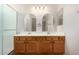 Bathroom featuring a double vanity, ample lighting, and a glass-enclosed shower at 12238 W Monroe St, Avondale, AZ 85323