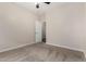 Cozy bedroom featuring carpeted floors, neutral-colored walls, and an open doorway at 12238 W Monroe St, Avondale, AZ 85323
