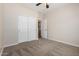 Bedroom featuring plush carpeting, a ceiling fan, and a closet with sliding doors at 12238 W Monroe St, Avondale, AZ 85323