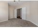 Bedroom showcases neutral walls, carpeted floors, and double doors leading to another room at 12238 W Monroe St, Avondale, AZ 85323