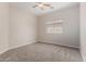 Neutral bedroom with a ceiling fan, a window with blinds, and carpeted floors at 12238 W Monroe St, Avondale, AZ 85323