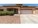 Charming single-story home with a tile roof, low-maintenance landscaping, and a two-car garage at 12238 W Monroe St, Avondale, AZ 85323