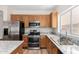 Well-equipped kitchen with granite countertops, stainless steel appliances, and wooden cabinetry at 12238 W Monroe St, Avondale, AZ 85323