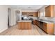 Spacious kitchen with wooden cabinetry, stainless steel appliances, and a center island at 12238 W Monroe St, Avondale, AZ 85323