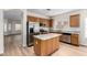 Modern kitchen showcasing stainless steel appliances, light countertops, and an adjacent living space at 12238 W Monroe St, Avondale, AZ 85323