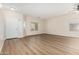 Bright living room showcasing wood floors, neutral paint, and natural light from the picture window at 12238 W Monroe St, Avondale, AZ 85323