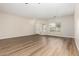 Open living room featuring wood floors, a front door, and a large picture window for natural lighting at 12238 W Monroe St, Avondale, AZ 85323