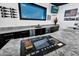 Custom bar area featuring a playful slot machine, granite countertops, and view of the pool for entertainment at 13209 N 17Th Pl, Phoenix, AZ 85022