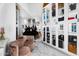 Chic dressing room with mirrored walls, stylish seating, and designer display cases at 13209 N 17Th Pl, Phoenix, AZ 85022