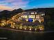 Stunning desert home with captivating pool and cascading waterfall under a colorful dusk sky at 13209 N 17Th Pl, Phoenix, AZ 85022