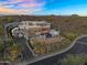 Aerial view of luxury home with cascading pool, lush desert landscaping, and mountain backdrop at 13209 N 17Th Pl, Phoenix, AZ 85022