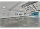 Spacious garage with epoxy flooring, modern lighting, and decorated walls at 13209 N 17Th Pl, Phoenix, AZ 85022