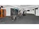 Spacious home gym featuring cardio equipment, weights, wall-mounted TV, and a private sauna at 13209 N 17Th Pl, Phoenix, AZ 85022