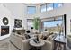 Bright living room boasts soaring ceilings, modern fireplace, and seamless indoor-outdoor flow to scenic patio at 13209 N 17Th Pl, Phoenix, AZ 85022