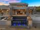 Stunning modern home featuring an eye-catching pool with a cascading water feature and beautiful stone accents at 13209 N 17Th Pl, Phoenix, AZ 85022