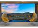 Breathtaking sunset view from the patio featuring a pool and swinging chairs with desert landscape at 13209 N 17Th Pl, Phoenix, AZ 85022