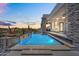 Gorgeous backyard oasis with a sparkling pool, covered patio, and desert landscaping at 13209 N 17Th Pl, Phoenix, AZ 85022