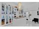 Spacious walk-in closet with glass door cabinets, marble floors and central island at 13209 N 17Th Pl, Phoenix, AZ 85022