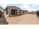 Backyard featuring neutral colored stucco walls, covered patio, and neutral colored rock landscaping at 13503 W Calle De Baca --, Peoria, AZ 85383