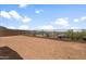 Fenced backyard features neutral colored rock landscaping and block perimeter fencing and desert views at 13503 W Calle De Baca --, Peoria, AZ 85383
