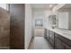 Modern bathroom featuring double vanity, granite counters, tiled flooring, and a separate tiled shower stall at 13503 W Calle De Baca --, Peoria, AZ 85383
