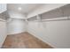Bright walk-in closet featuring tile floors, white walls, and shelving with metal clothing rods at 13503 W Calle De Baca --, Peoria, AZ 85383