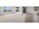 Spacious living room featuring carpeted and hardwood flooring with large windows and natural light at 13503 W Calle De Baca --, Peoria, AZ 85383