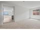 Open-concept living room with neutral carpet, and a window providing view and natural light at 13503 W Calle De Baca --, Peoria, AZ 85383