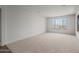 Bright, carpeted living room featuring large windows with scenic views at 13503 W Calle De Baca --, Peoria, AZ 85383