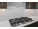 Close-up of a modern, stainless steel KitchenAid gas cooktop with white subway tile backsplash at 13503 W Calle De Baca --, Peoria, AZ 85383