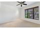 Bright bedroom featuring a ceiling fan and a large window with blinds at 20660 N 40Th St # 1089, Phoenix, AZ 85050