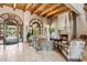 Open-concept living space with fireplace, exposed beams, and tiled flooring at 20660 N 40Th St # 1089, Phoenix, AZ 85050