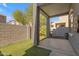 Charming covered back patio, with artificial grass and brick surround, provides a low maintenance retreat at 2402 E 5Th St # 1621, Tempe, AZ 85288