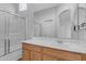 Bright bathroom featuring a tub-shower combination, wood vanity, large mirror, and abundant lighting at 2402 E 5Th St # 1621, Tempe, AZ 85288