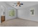 Large carpeted bedroom with a ceiling fan and natural light from the large windows at 2402 E 5Th St # 1621, Tempe, AZ 85288