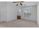 Spacious bedroom with a large window, ceiling fan and an arched entry to the ensuite bathroom at 2402 E 5Th St # 1621, Tempe, AZ 85288