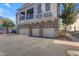 Exterior showcasing a well-maintained townhome with a three-car garage and balcony at 2402 E 5Th St # 1621, Tempe, AZ 85288
