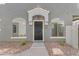 Stylish townhome entry featuring a dark-colored front door with a covered porch at 2402 E 5Th St # 1621, Tempe, AZ 85288