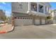 Townhome garages and stone accents beneath balcony of neutral colored building at 2402 E 5Th St # 1621, Tempe, AZ 85288